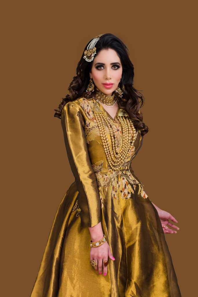 A person in a gold dress Description automatically generated with medium confidence